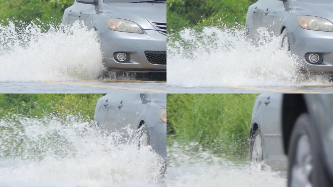 街道上行驶的汽车被洪水淹没。