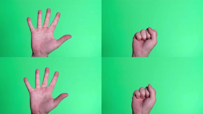 男性的手紧握在彩色按键屏幕的绿色背景上。接口概念。