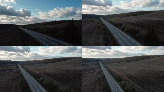 无人机的航拍镜头打开了道路的视野，两边都是无草的土地