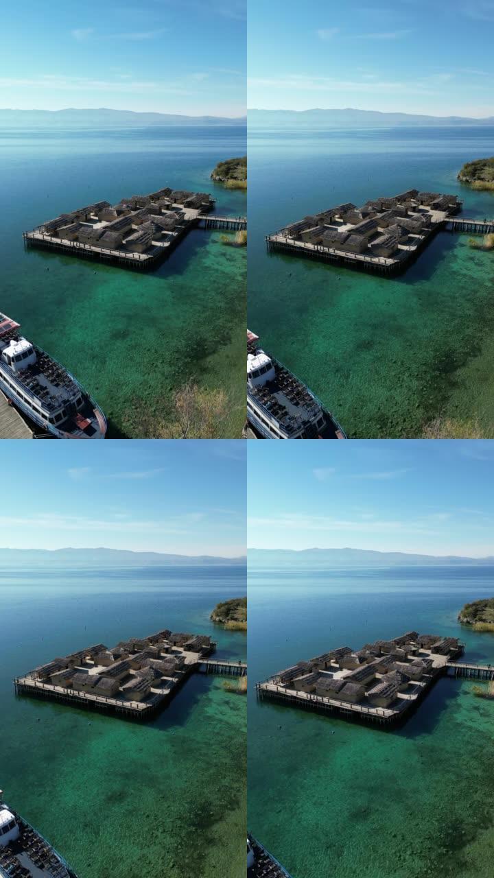 北马其顿奥赫里德湖边缘的历史青铜时代定居点的垂直视频 (空中4k无人机镜头)