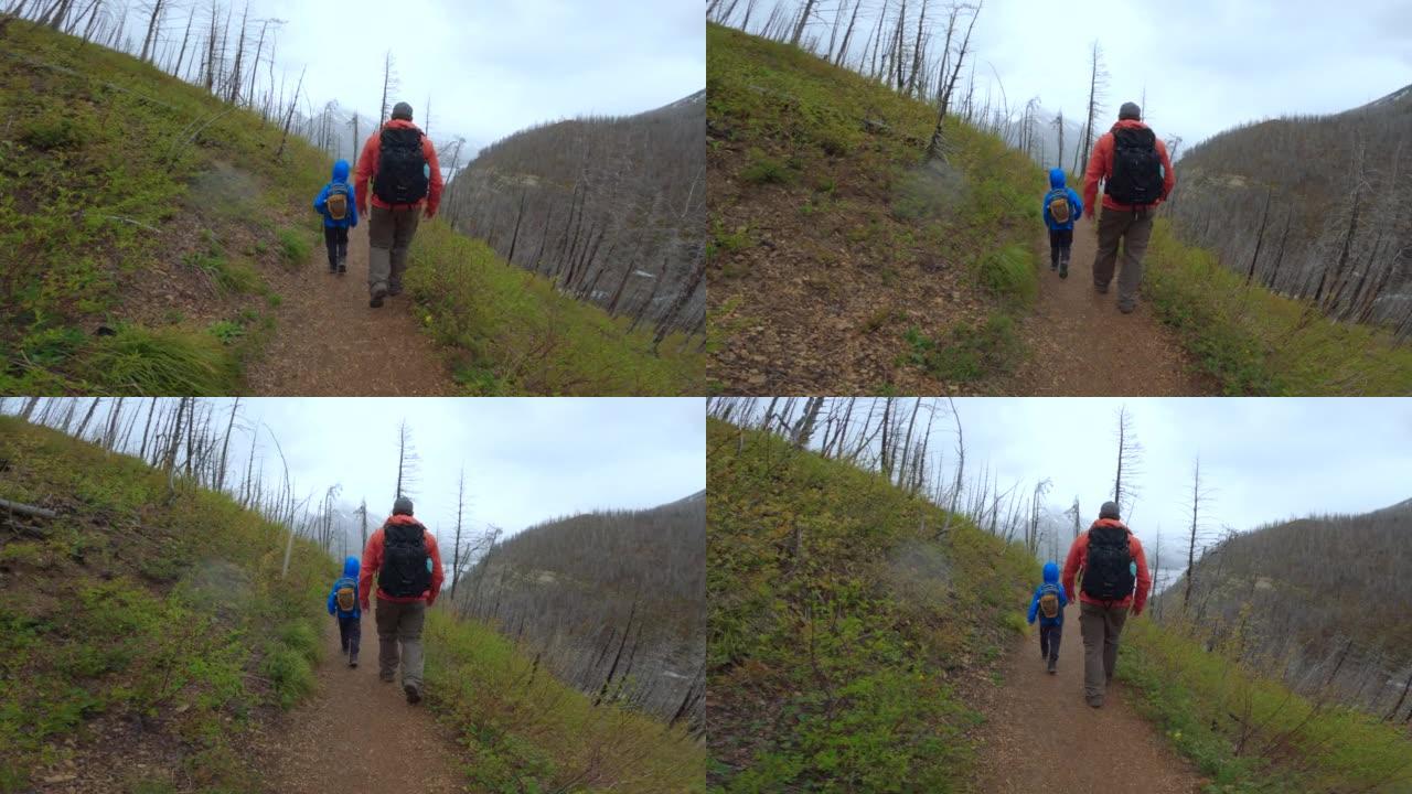 父亲和儿子在加拿大艾伯塔省沃特顿湖国家公园徒步旅行