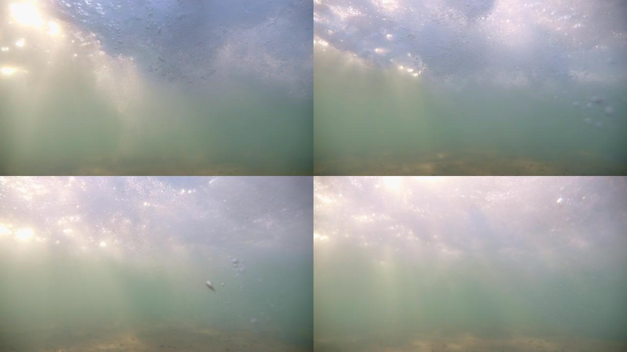 带有太阳光线的海底穿透了水面。水面上方耀眼的太阳。阳光下闪烁的水泡。专注于泡沫。完美的背景。版本3