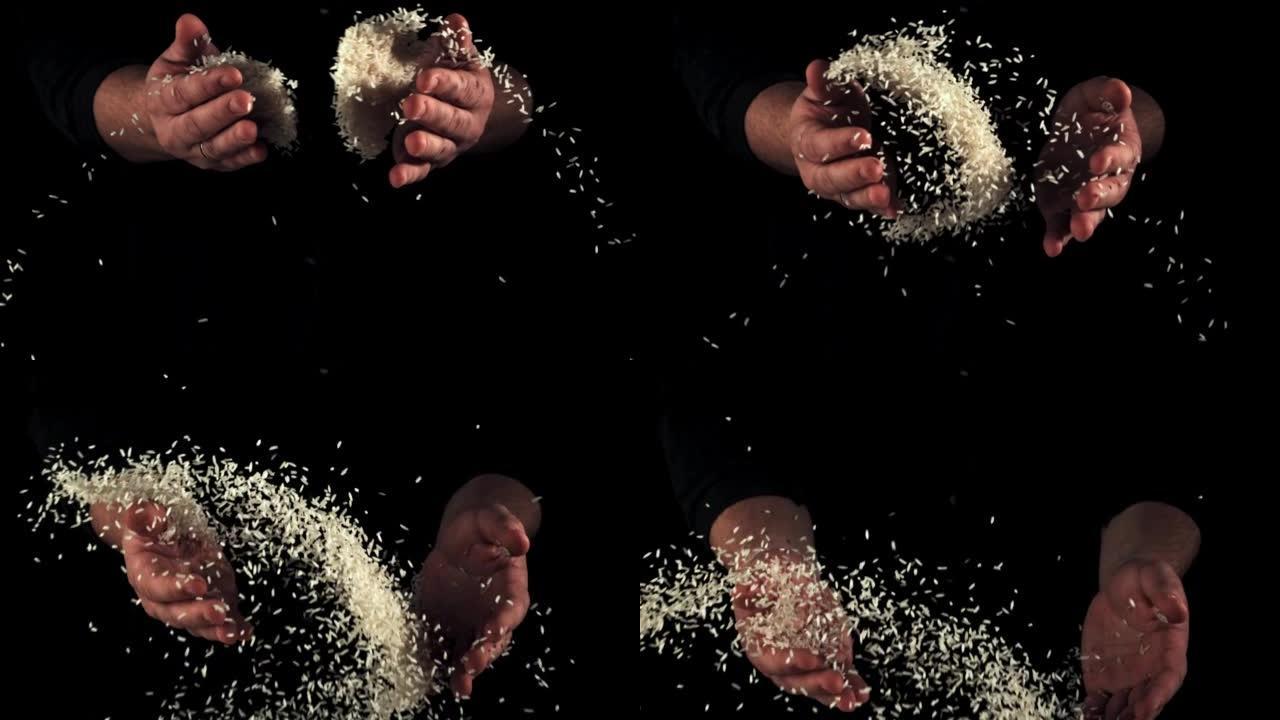 男人的手扔了几把生脆的米饭。以1000 fps的高速相机拍摄。