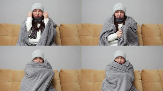 成年妇女用毯子盖住并试图在家中热身