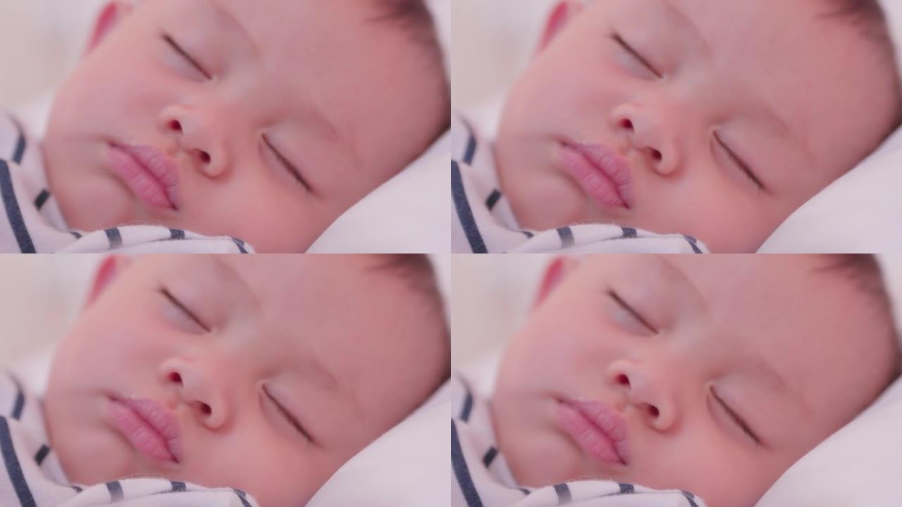脸部亚洲可爱男婴睡在家庭卧室的白色床上的特写。