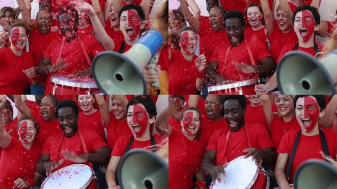 多种族红色运动球迷一边尖叫，一边支持他们的球队-足球支持者在比赛中玩耍-世界杯概念