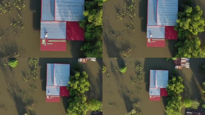 飞行无人机和洪水灾害沉没房屋的俯视图