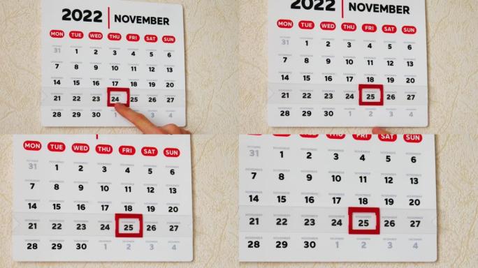 一个漂亮的2022年11月挂历页面的特写，一只男性的手将红色光标移动到黑色星期五的日期