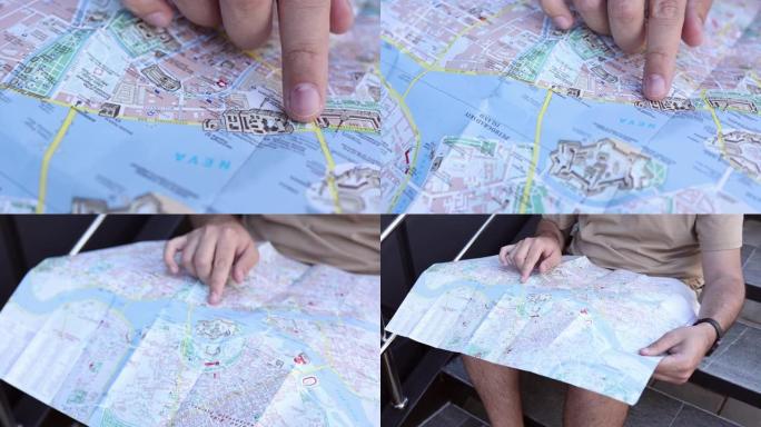 一个男人用手指在地图上寻找方向的特写镜头