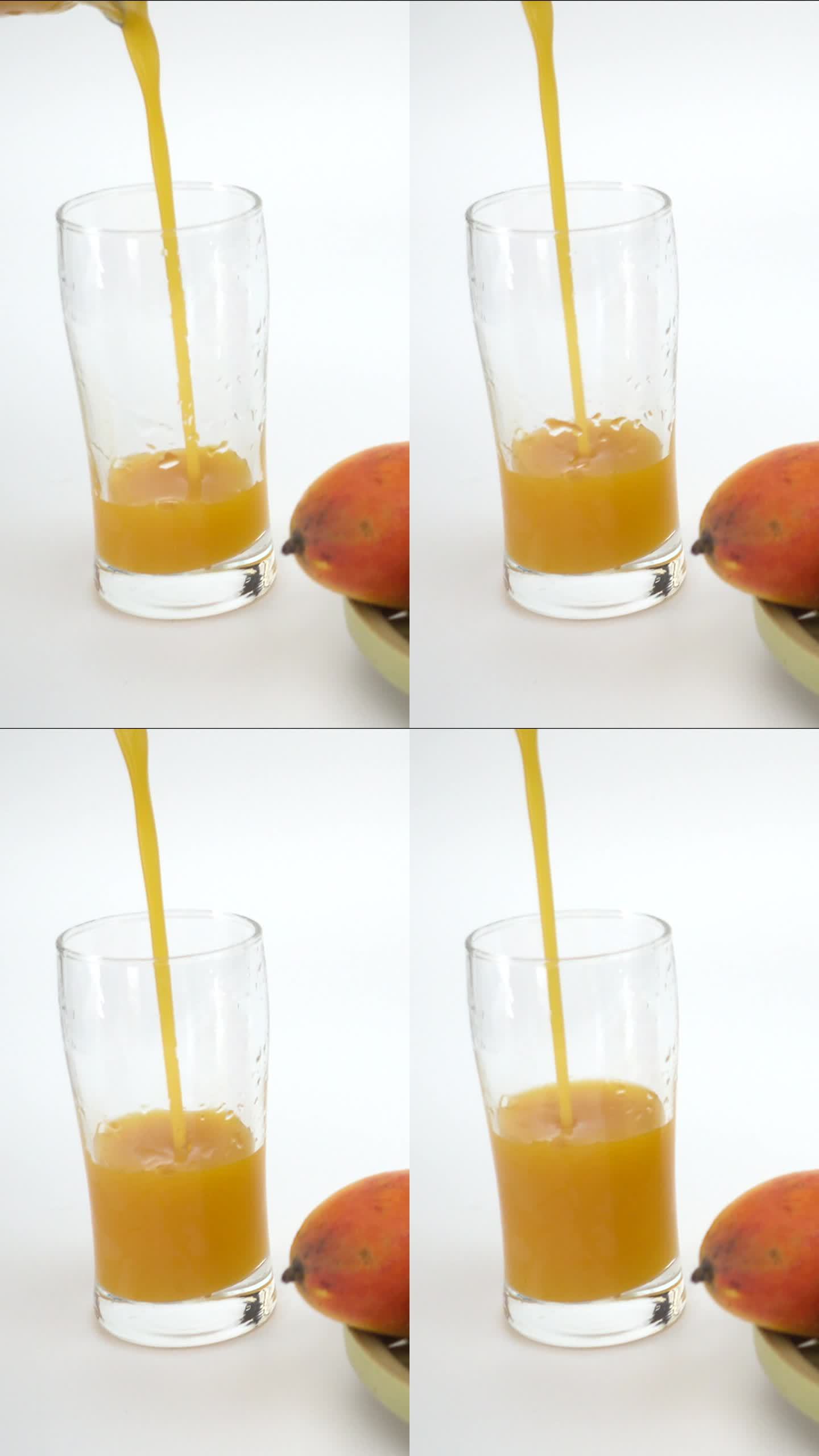 新鲜芒果汁倒入杯中（竖屏）