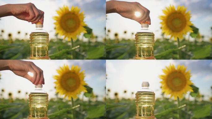 女性的手在日落时分在田野里盛开的向日葵的背景下打开一瓶葵花籽油。种植向日葵作为食用油。农业综合企业、