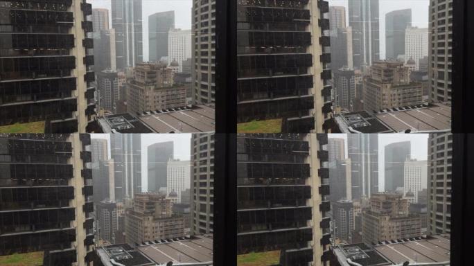 雨滴落在城市办公楼上层窗户上的视图