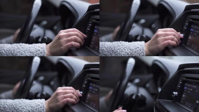 女性手控制收音机或运动中的汽车音乐