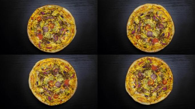 新鲜出炉的比萨饼的俯视图，西红柿和奶酪马苏里拉在托盘上旋转