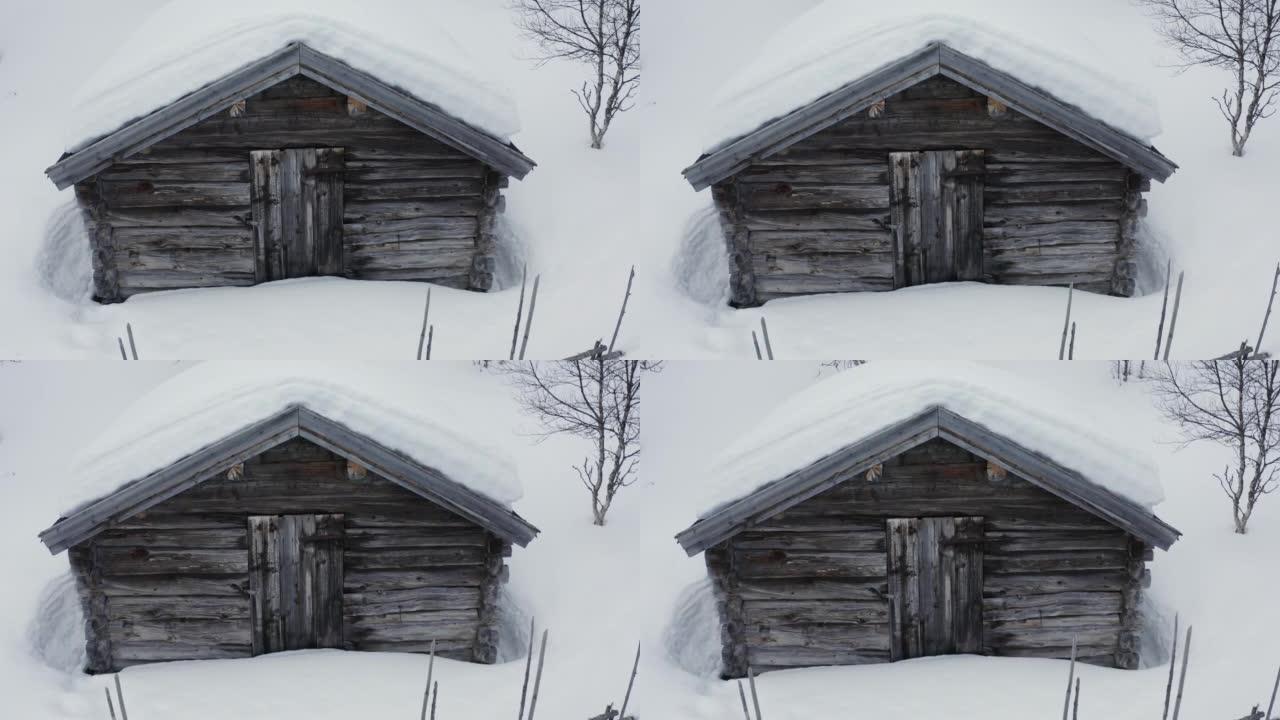 瑞典雪地中一座旧木屋的航拍画面。