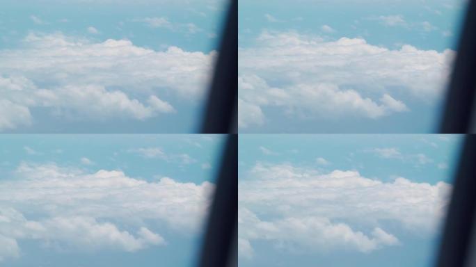 通过飞机窗口的云视远摄