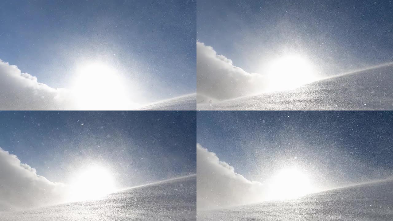 在寒冷的冬天早晨，暴风雪，暴风雪和积雪在山上漂流的特写镜头，阳光照耀着。慢动作