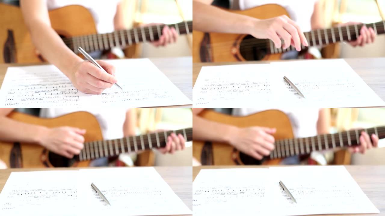 手在吉他上写歌音符
