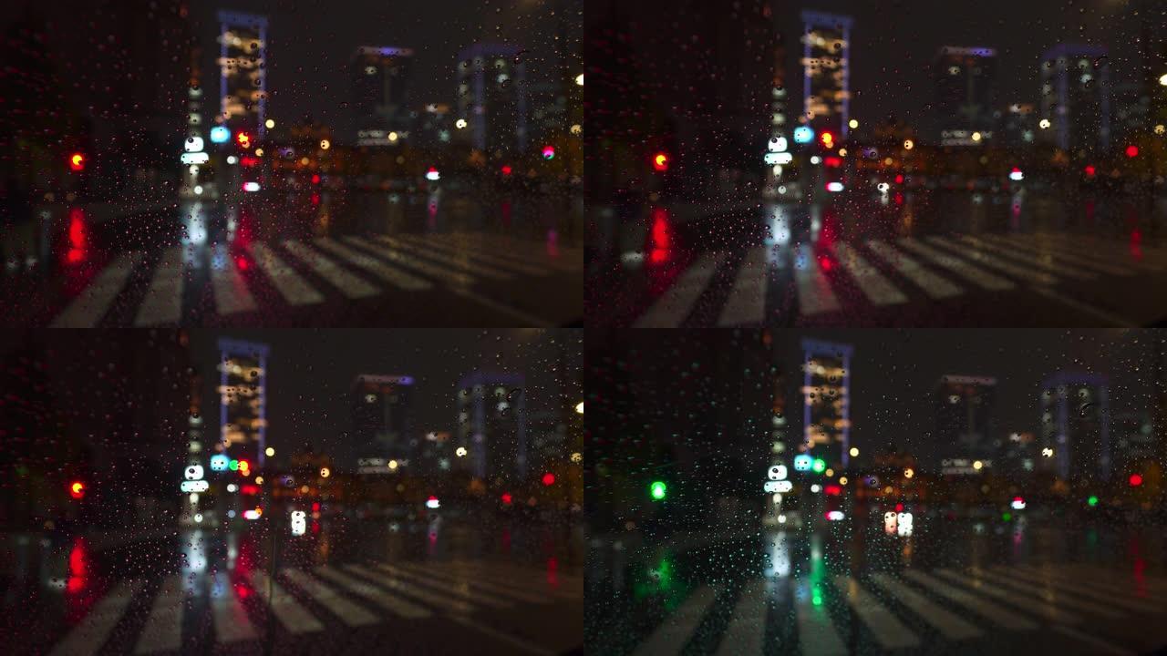 夜间市区下雨天交通散焦，车灯