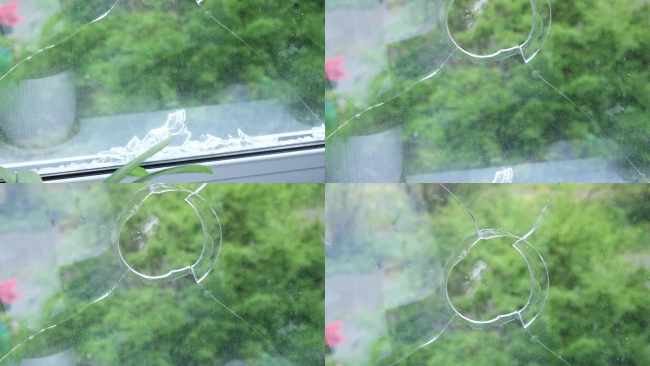 窗框碎玻璃的4k视频，特写，玻璃上的孔