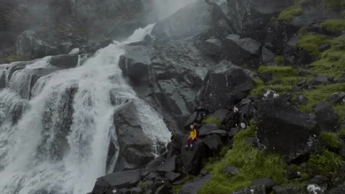 挪威山区瀑布附近徒步旅行的妇女的鸟瞰图