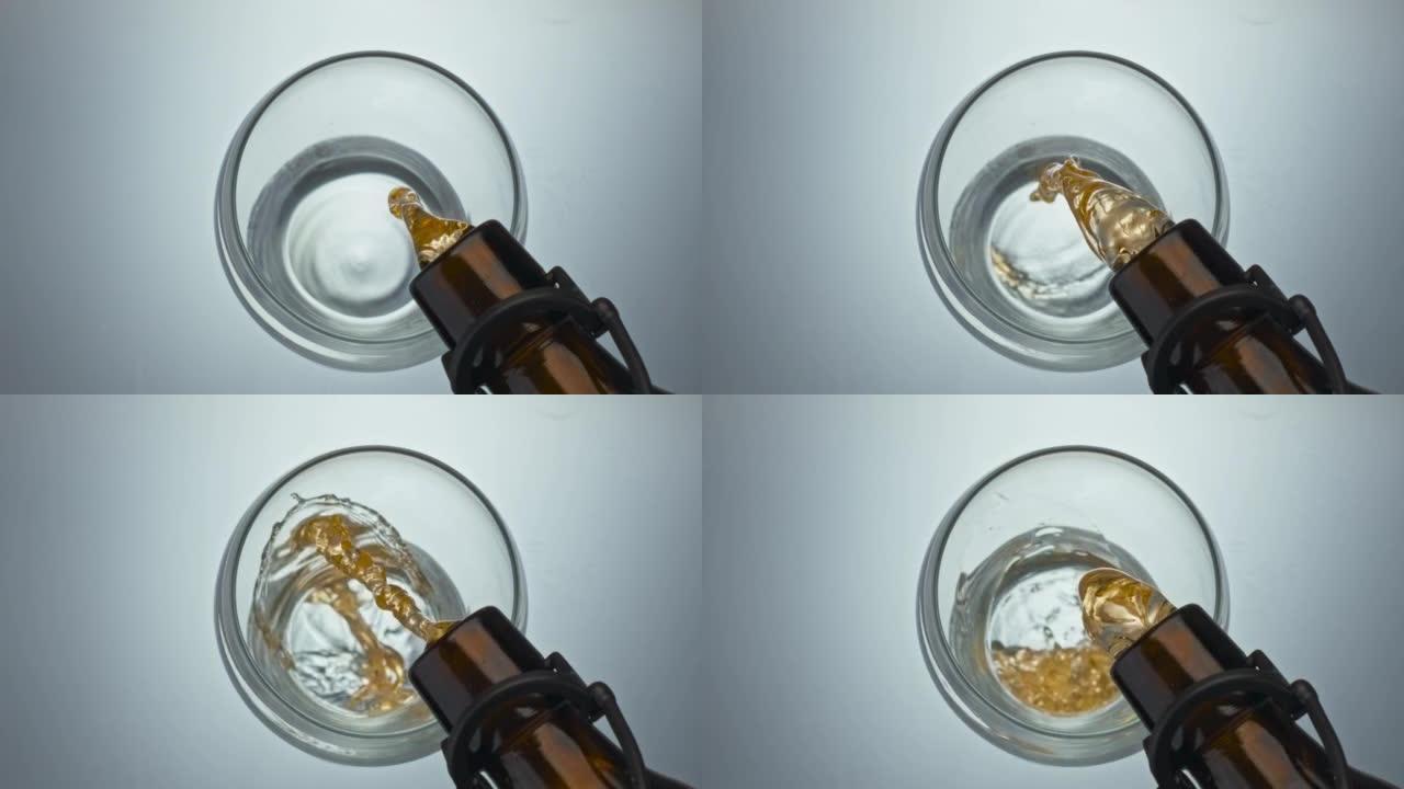 工艺啤酒灌装玻璃特写。清爽麦芽酒喷射起泡浇注容器