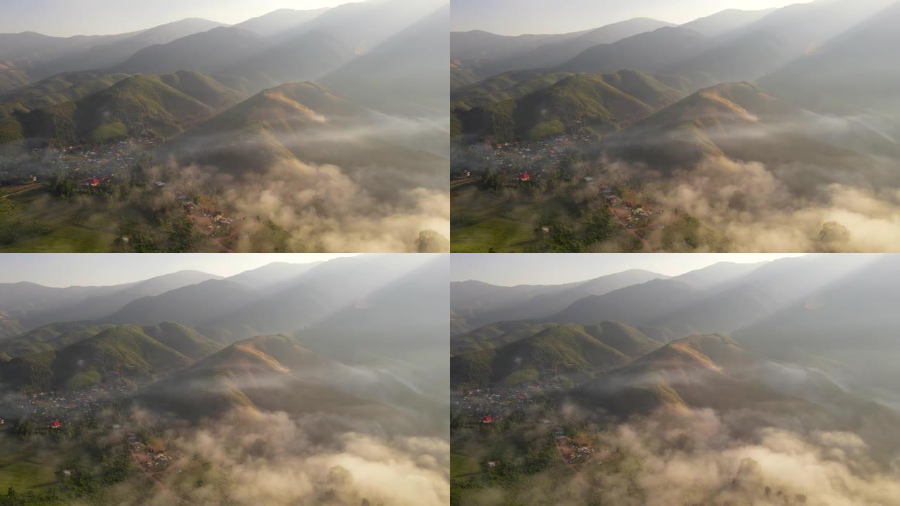 早上飞越村庄，周围是局部的山脉和雾气