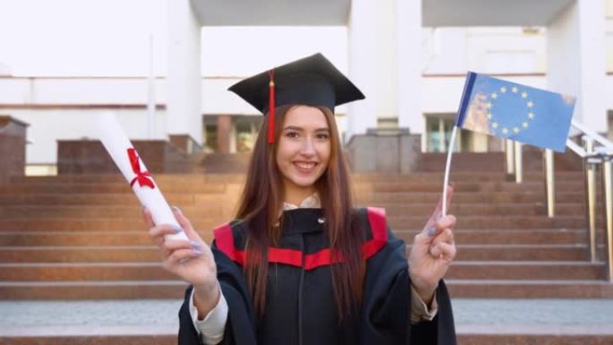 硕士毕业生持有高等教育文凭和欧盟旗帜