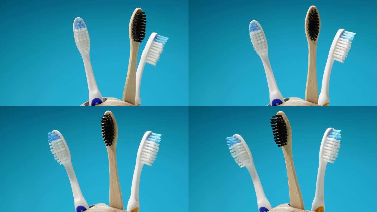 一组牙刷在蓝色背景的转盘上旋转。木制生态牙刷