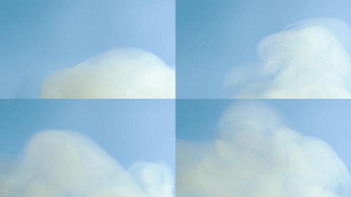蓝色背景上的烟。白雾映衬着天空。天空中云的形成。慢动作。介绍，结尾。镜头，烟雾的质地。均衡器，视频效