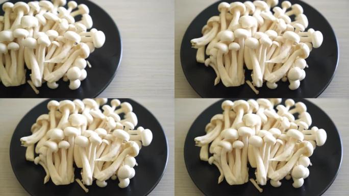 新鲜白色山毛榉蘑菇或白色灵芝蘑菇放在盘子里