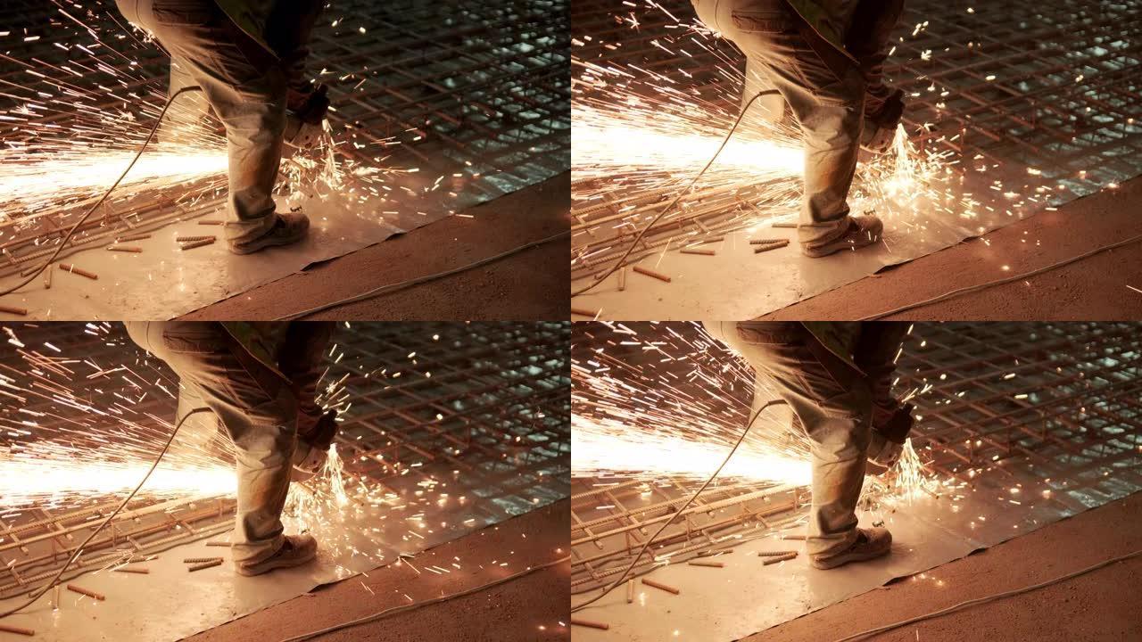 工业专业工人正在用圆锯切割金属钢筋。建造一个工厂，机库