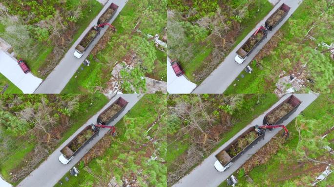 飓风伊恩·特惠善后恢复自卸车的俯视图，从佛罗里达州的乡村街道上捡起树枝碎片。处理自然灾害的后果