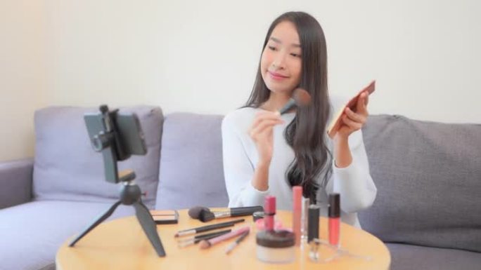年轻的亚洲女性在互联网上评论化妆品
