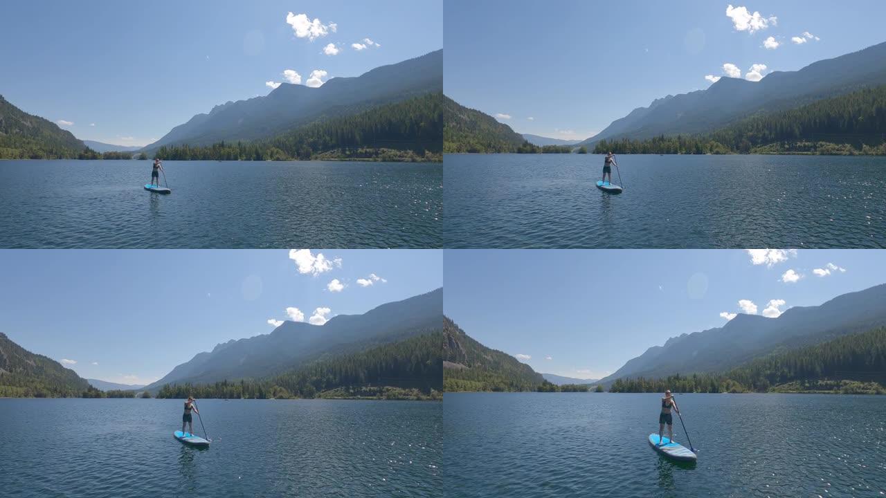 站立划桨寄宿生 (SUP) 在湖上享受宁静的时光