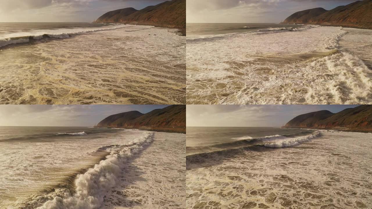 巨大的风暴浪潮，棕色的泥水冲向加利福尼亚海岸