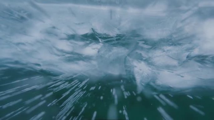 关闭透明蓝冰中裂缝和气泡的背景。前景模糊