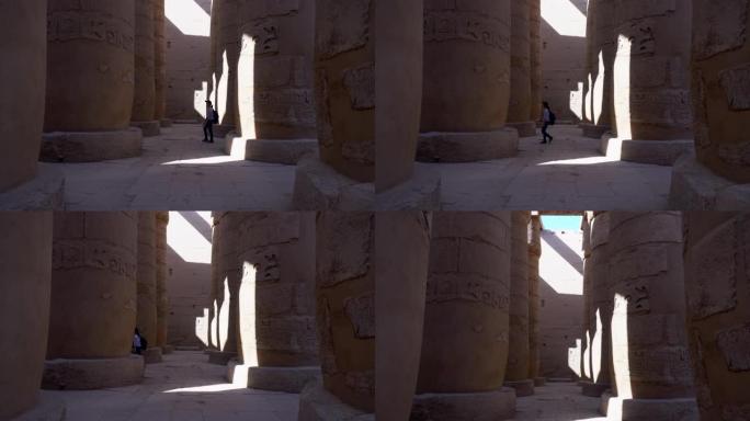 游客漫步在卡纳克神庙卢克索埃及的大柱子上进行比较