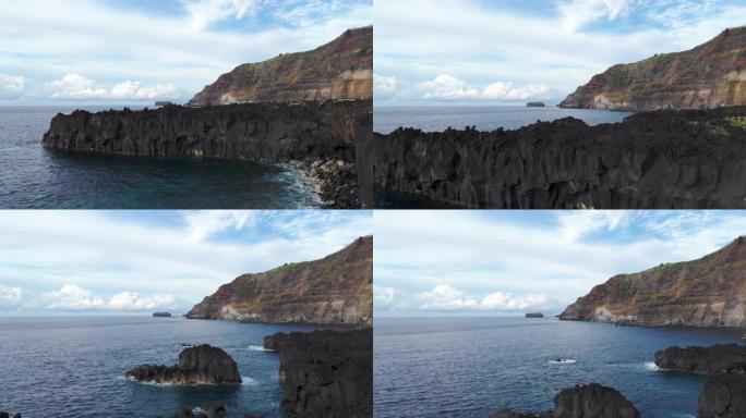 在亚速尔群岛Ponta Da Ferraria海岸线的火山岩上方飞行