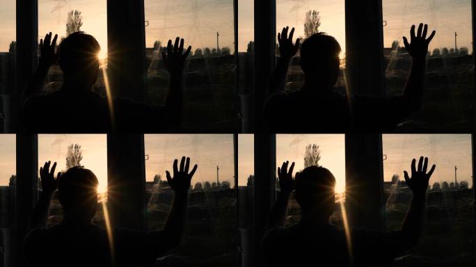 乌克兰战争期间，一个悲伤的人在日落时看着窗外。一个年轻人在火箭爆炸的密封窗户前。在家中沮丧的战争男子