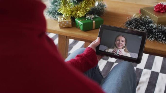 一名白化病男子挥舞着平板电脑，与屏幕上微笑的女子进行圣诞视频通话