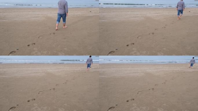 脚印，男人走在沙滩上的脚印可以看到