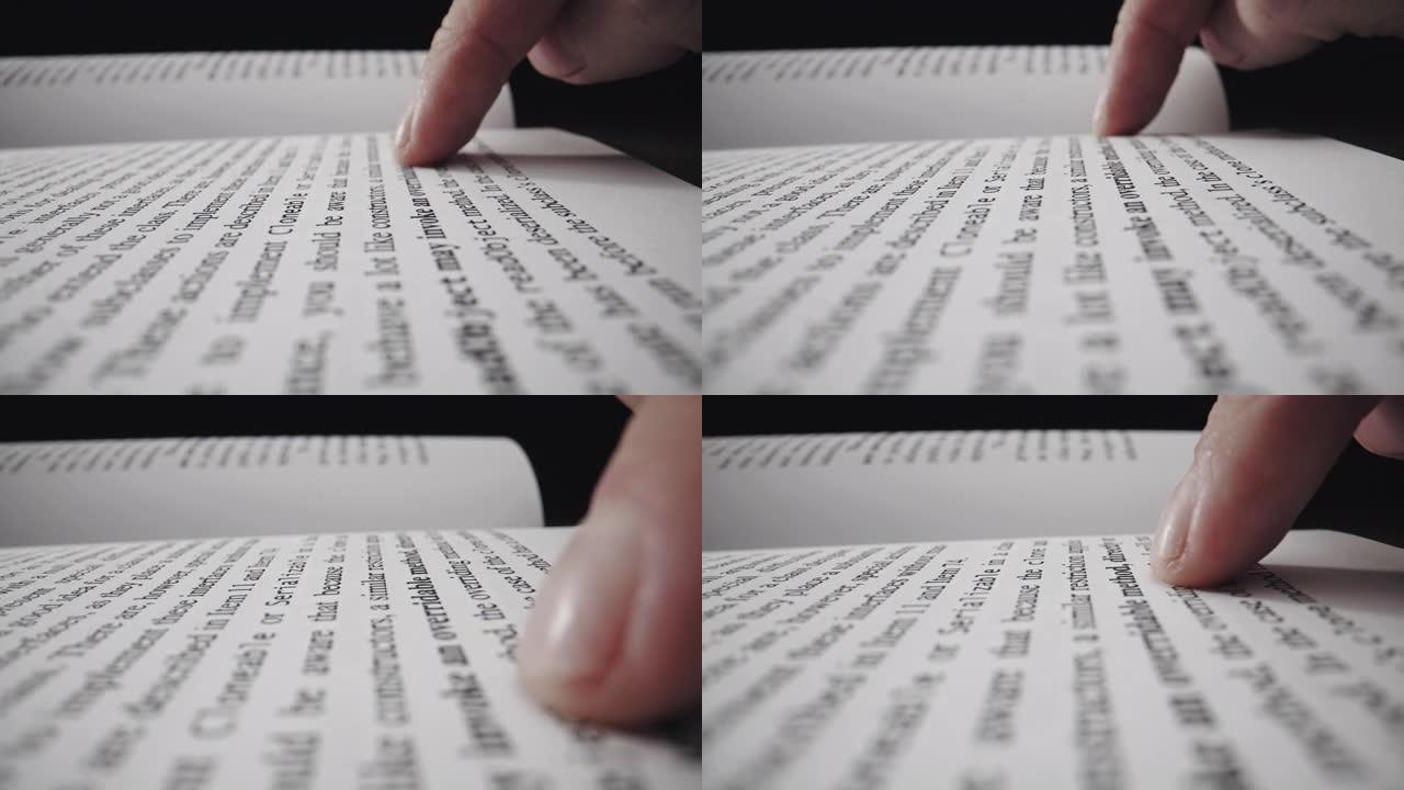 一个男人在看书时用食指在文字下划线的裁剪视图