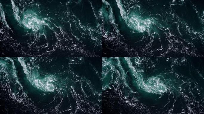 在涨潮和退潮期间，河流和大海的水波相遇。深蓝色暴风雨海水表面白色泡沫和波浪图案，背景纹理