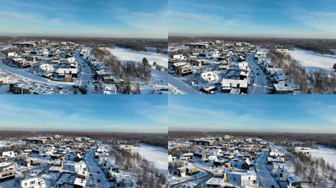 冬日日落中的联排别墅，鸟瞰图。冬天在城里下雪。