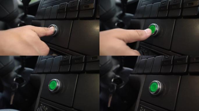 按下绿色电源点火按钮启动无钥匙汽车发动机。