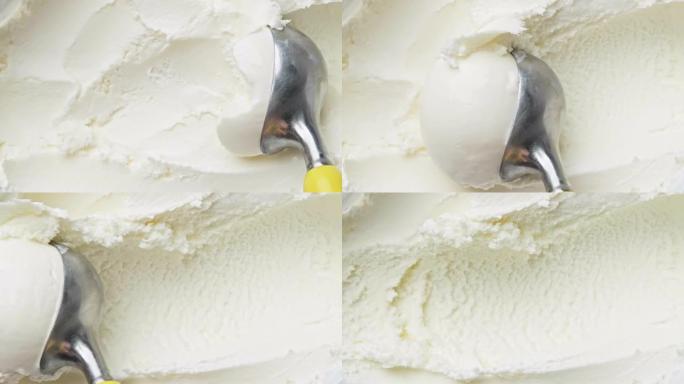 用勺子从容器中挖出美味的冰淇淋。香草冰淇淋甜点