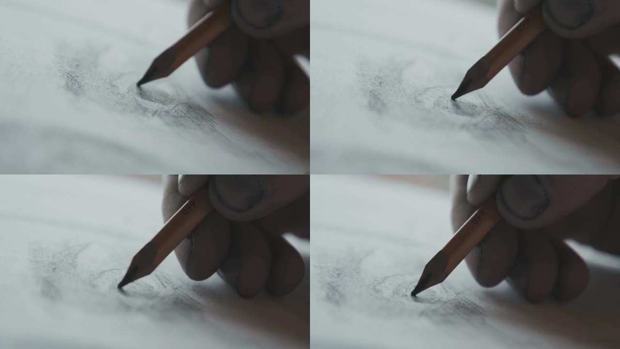 纸上铅笔画的特写。艺术。创造力。艺术家的手指被铅笔芯弄脏了。高技能。4K