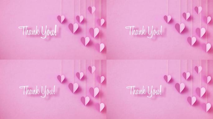 谢谢你的概念-谢谢你的信息挂在粉红色的心挂在粉红色的背景上