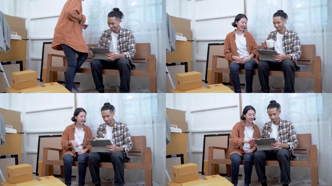 年轻夫妇在家里一起工作。女人坐在平板电脑的沙发上，男人看着她的工作。讨论客厅室内设计的新思路。